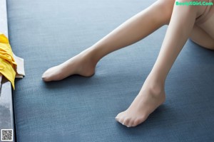 A close up of a woman's legs with a bandage on them.