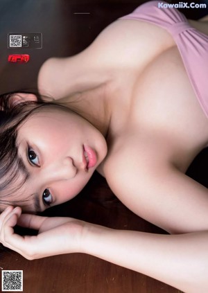 A woman in a white shirt is posing for a magazine.