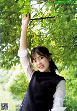 A young woman with a white headband is looking at the camera.