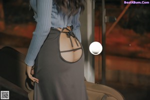 a woman standing in front of a mirror in a bathroom
