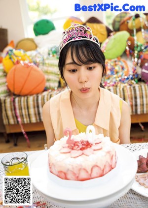 A woman laying on the floor next to a cake.