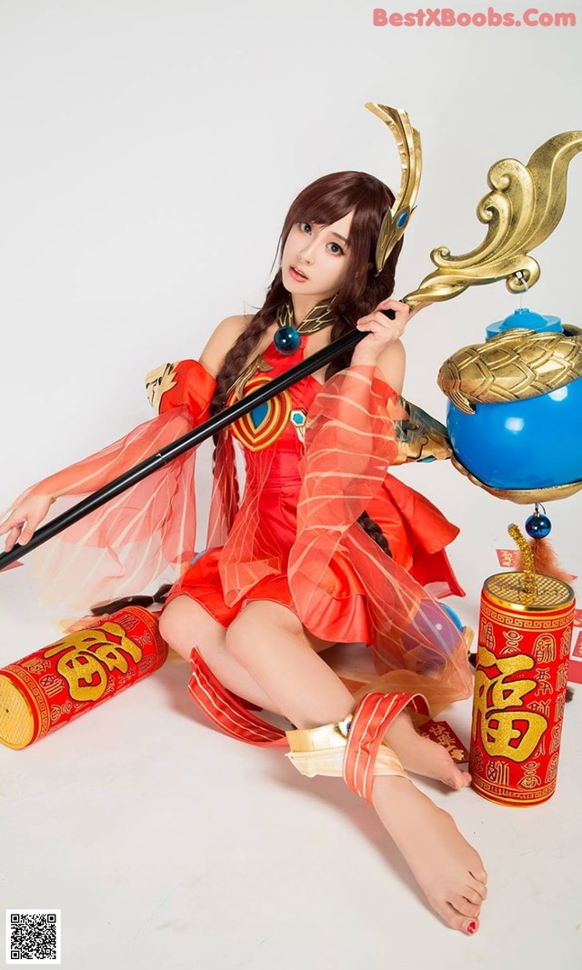 A woman in a red dress holding a sword and a blue pot.
