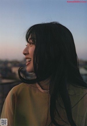 A magazine spread with a woman in a yellow dress.