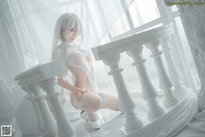 A woman in a white lingerie holding a sword.