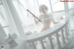 A woman in lingerie holding a sword in her hand.