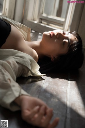 A woman sitting on a white chair in a room.