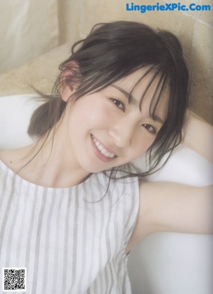 A woman sitting in a bathtub in a magazine.
