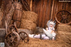 A woman in a white and blue outfit holding a stuffed animal.