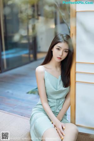 A woman sitting on top of a wooden table.