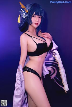 A woman in a black bikini holding a sword.