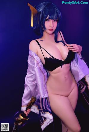 A woman in a black bikini holding a sword.