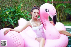 A woman in a white shirt and black skirt posing for a picture.